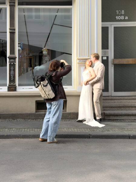 Fotografin und Hochzeitspaar beim Fotoshooting auf der Luisenstraße